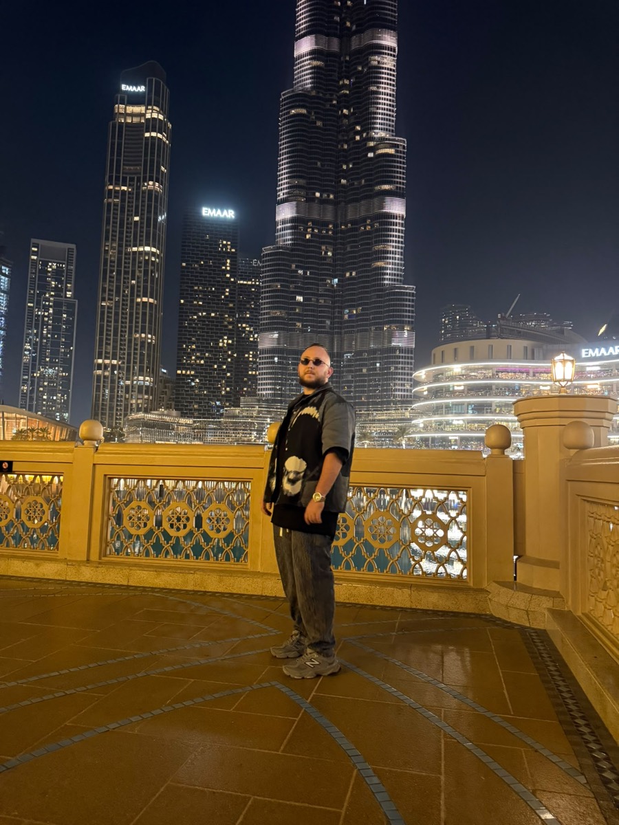 Posing in front of the Burj Khalifa and Dubai Mall at night