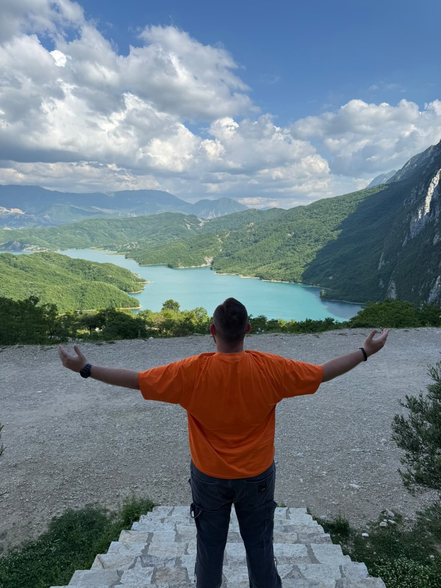Arms open above Bovilla Lake in Albania