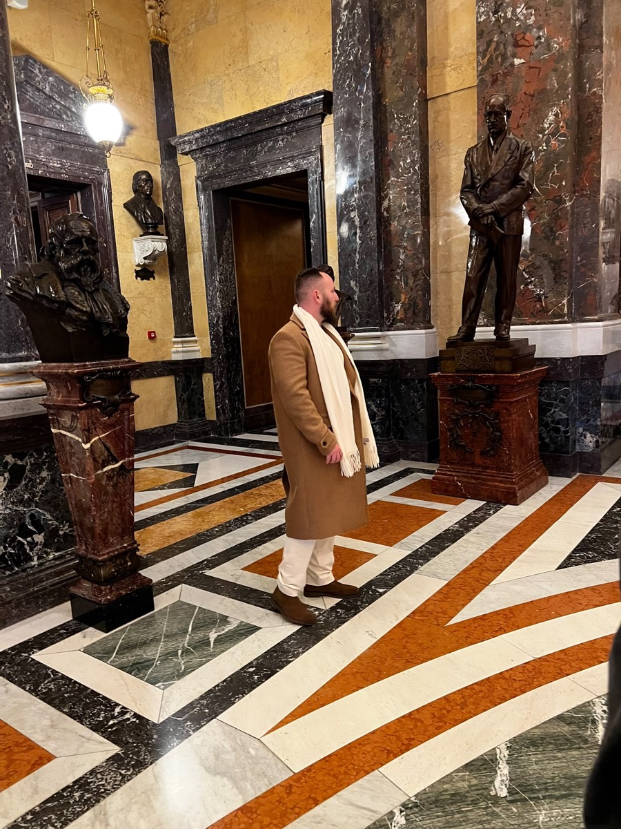 Walking past statues inside the National Museum in Prague
